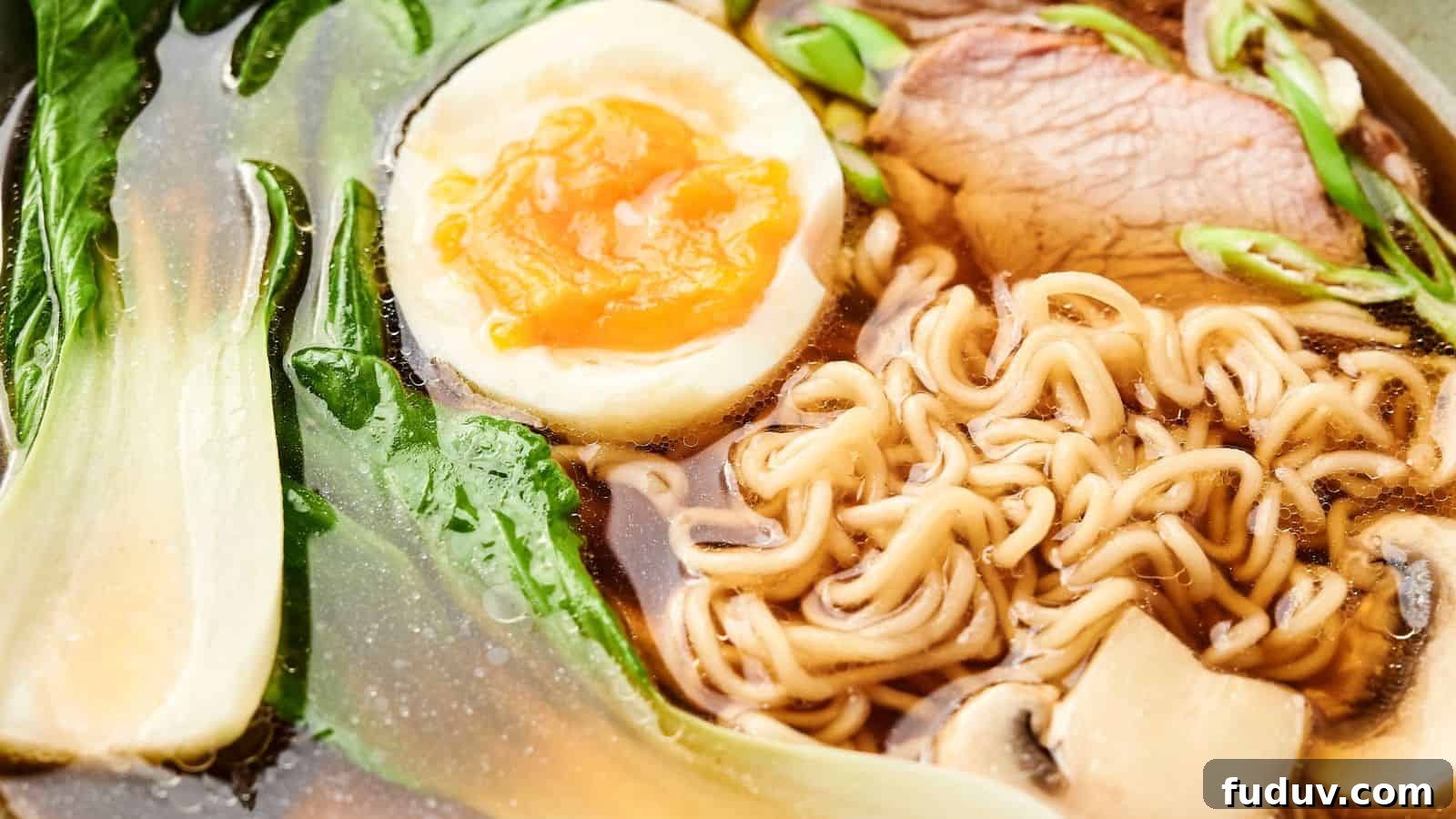 31 Cozy Cinnamon Recipes to Warm Your Home and Soul 18 Close-up of a bowl of ramen with noodles, a halved boiled egg, sliced meat, green leafy vegetables, and mushrooms in broth.