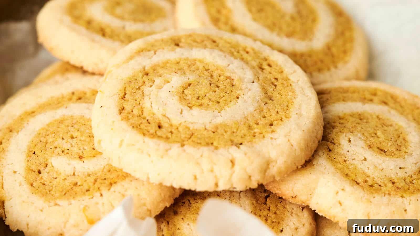 31 Cozy Cinnamon Recipes to Warm Your Home and Soul 25 Close-up of a stack of swirled cookies with a light and dark pattern, showcasing a golden brown color.