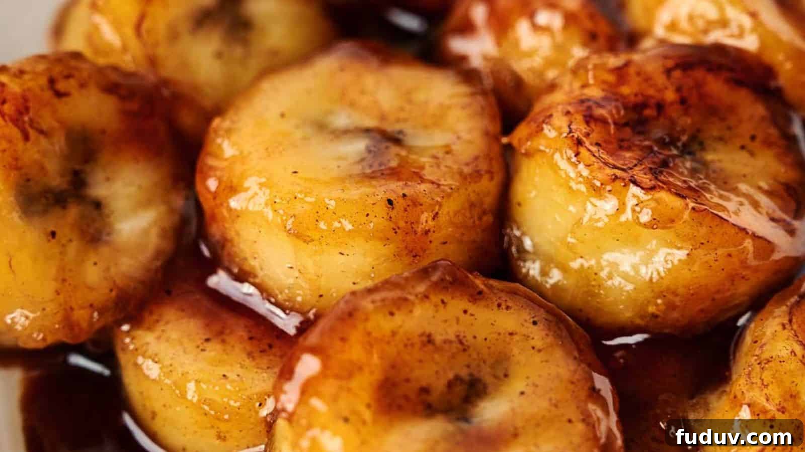 31 Cozy Cinnamon Recipes to Warm Your Home and Soul 29 A close up of a plate of fried bananas with sauce.