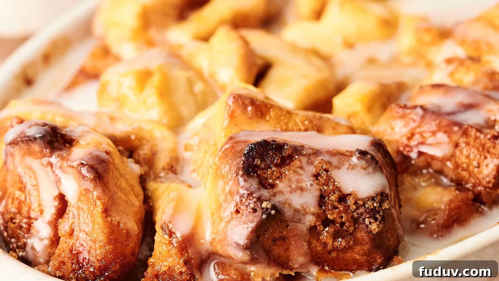 31 Cozy Cinnamon Recipes to Warm Your Home and Soul 31 Close-up of a dish of warm cinnamon rolls topped with white glaze.