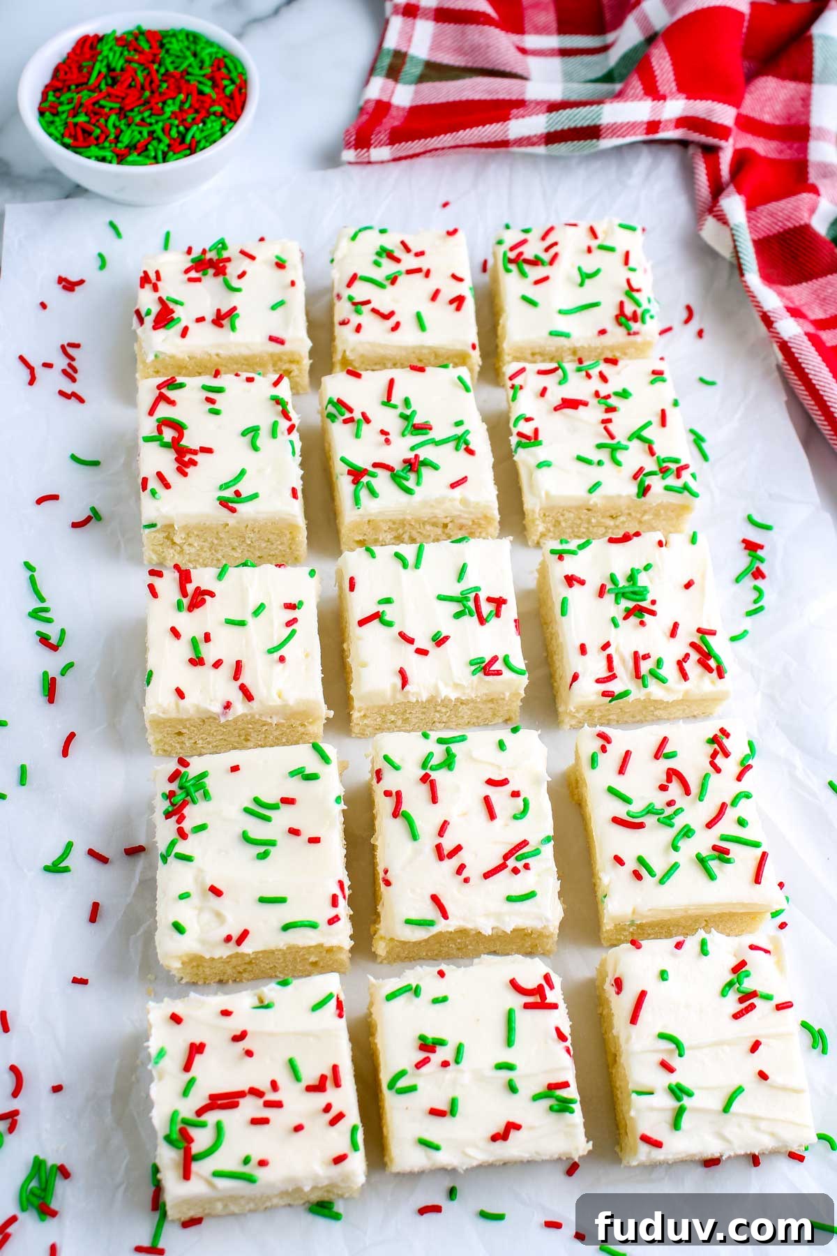 The finished Christmas Sugar Cookie Bars on a counter and garnished with red and green sprinkles.