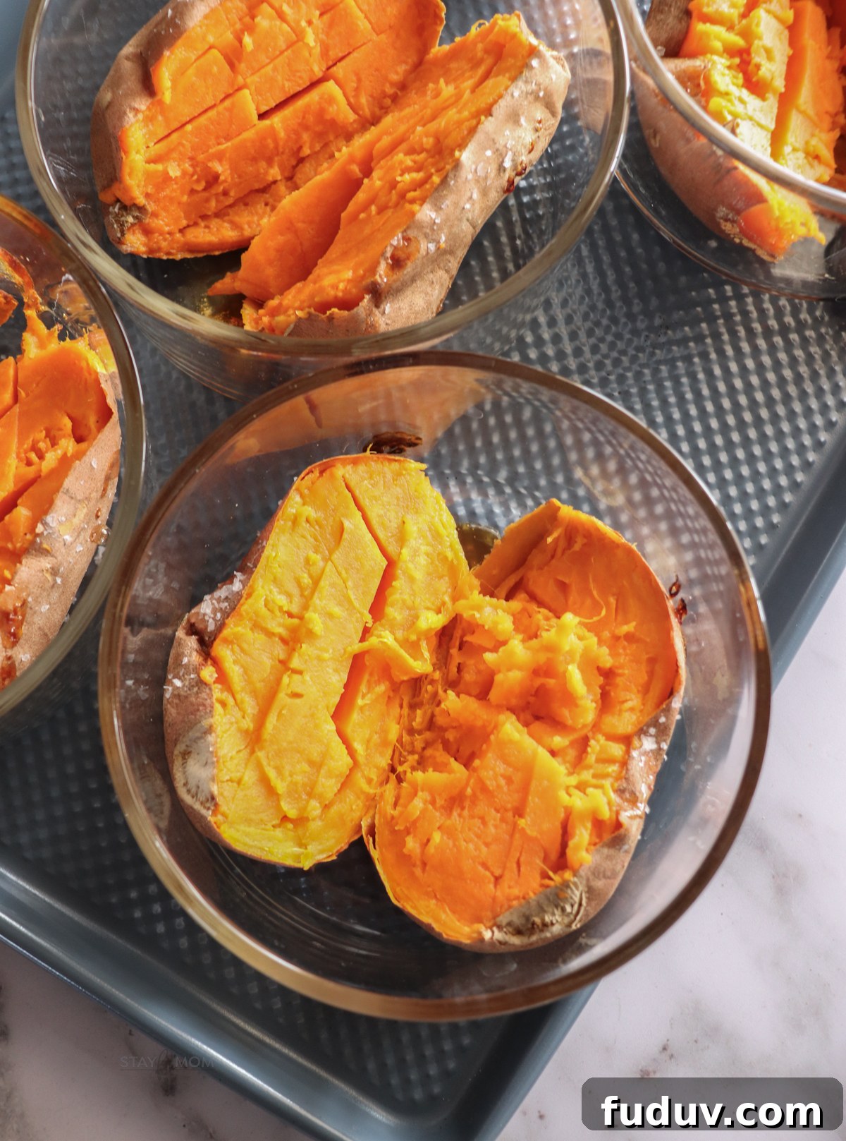 Baked Sweet Potato Bowls showing cooked sweet potato in glass meal prep bowl.