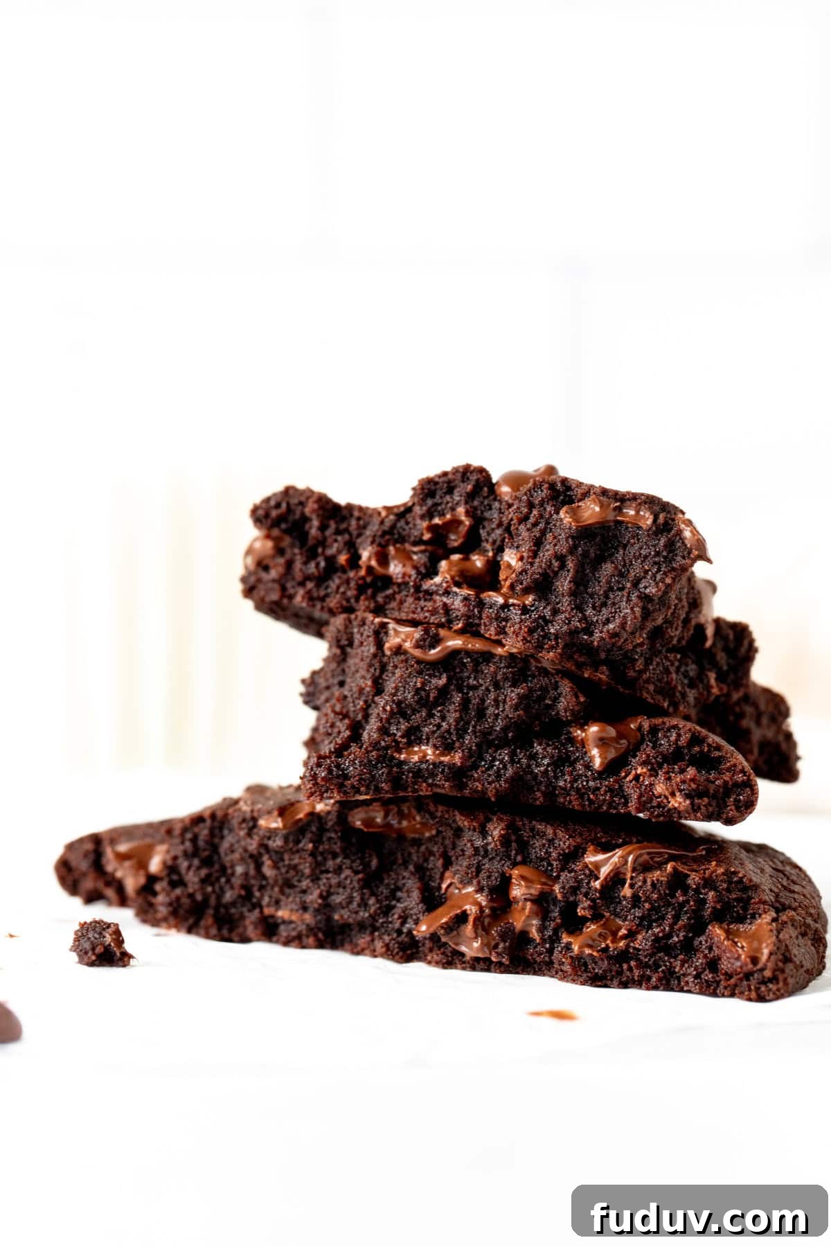 Single serving double chocolate cookie broken into pieces, with pieces stacked on top of each other