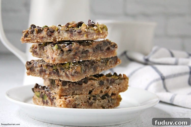 Cannoli Magic Bars recipe - the Italian variation of the popular layered magic cookie bars cookies stacked on plate