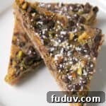 Cannoli Magic Bar Recipe: Creamy Ricotta Dessert Squares 2 magic bars cut into triangle bars on white plate