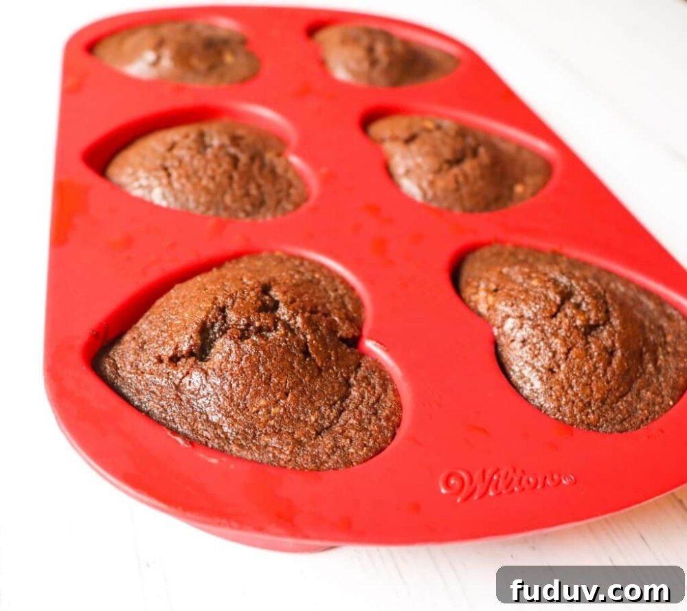 25 High-Protein, Low-Carb Breakfast Recipes to Start Your Day 14 Keto Chocolate Flaxseed Muffins in red heart silicone baking pan side view