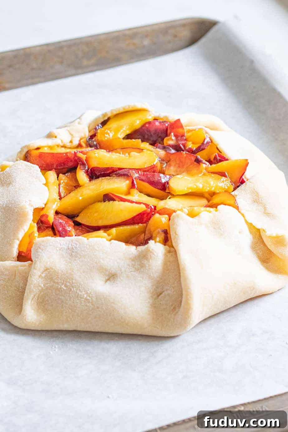 Peach Galette Recipe: Rustic Fresh Peach Tart for Summer 7 Uncooked peach galette on baking sheet