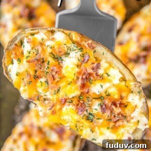 twice baked potato with cheese and bacon on a spatula
