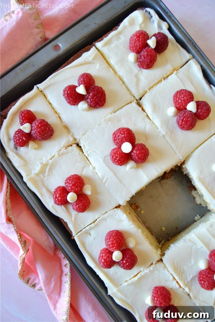 a pan of white chocolate raspberry cake slices 