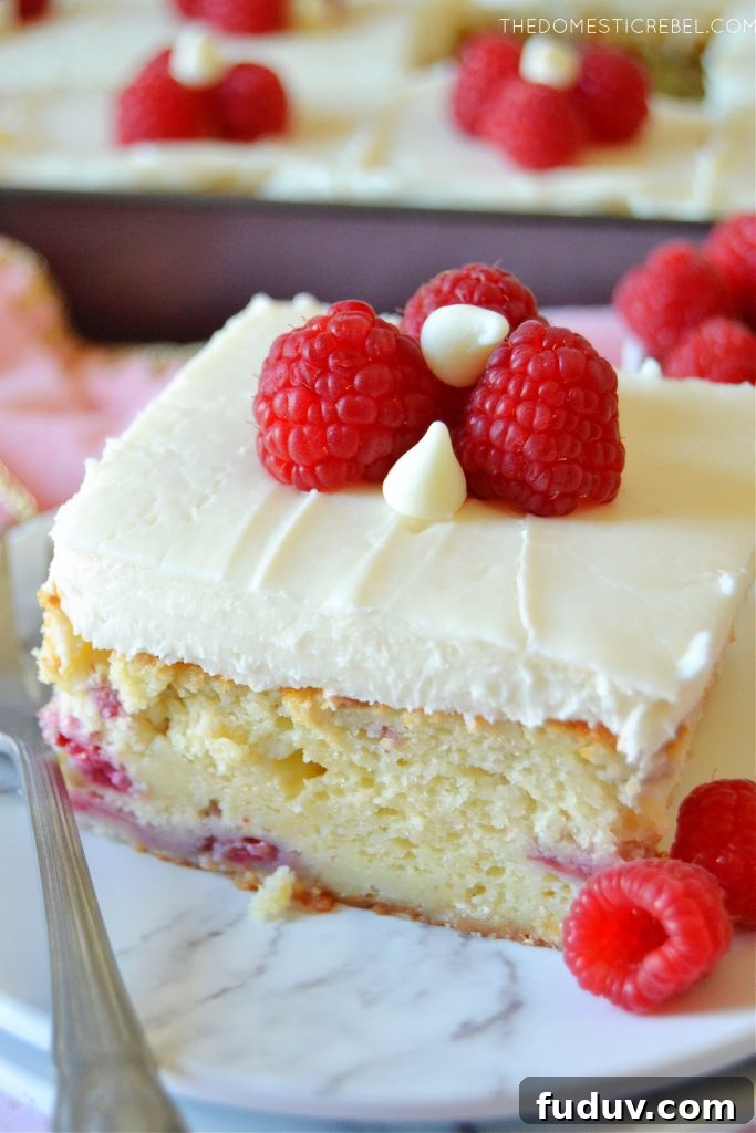 slice of white chocolate raspberry cake on a white plate