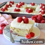 a square slice of white chocolate raspberry cake