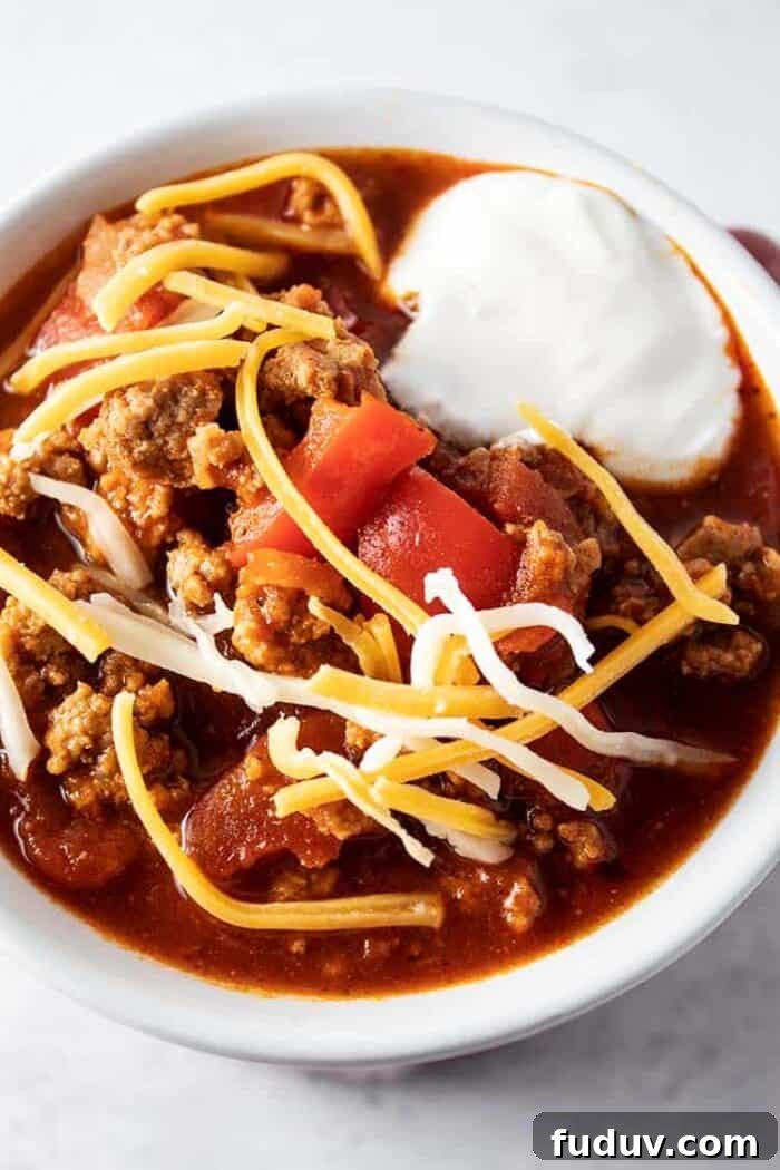 overhead view of low carb turkey chili with sour cream and cheese on top
