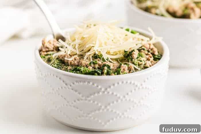 side view of a white bowl of low carb turkey soup with cheese on top