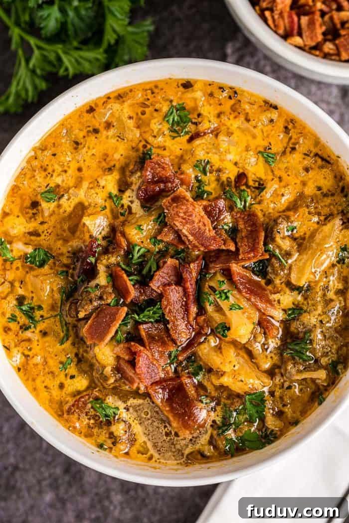 overhead view of bowl of keto cheeseburger soup with bacon on top