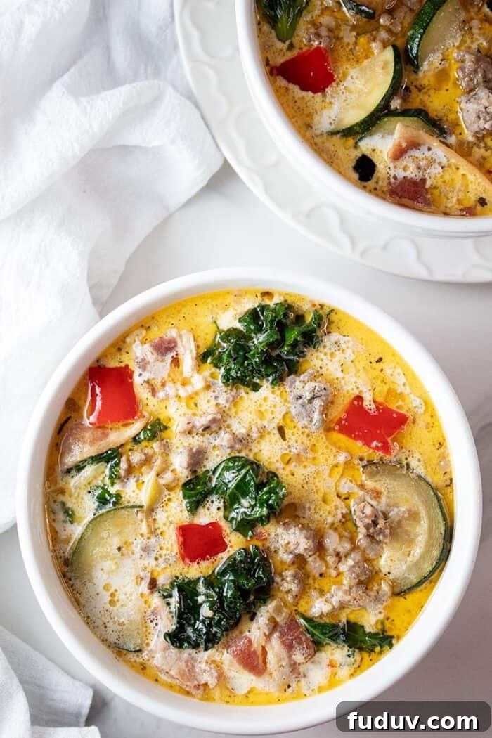 overhead view of Italian zuppa toscana soup in a white serving bowl with a spoon