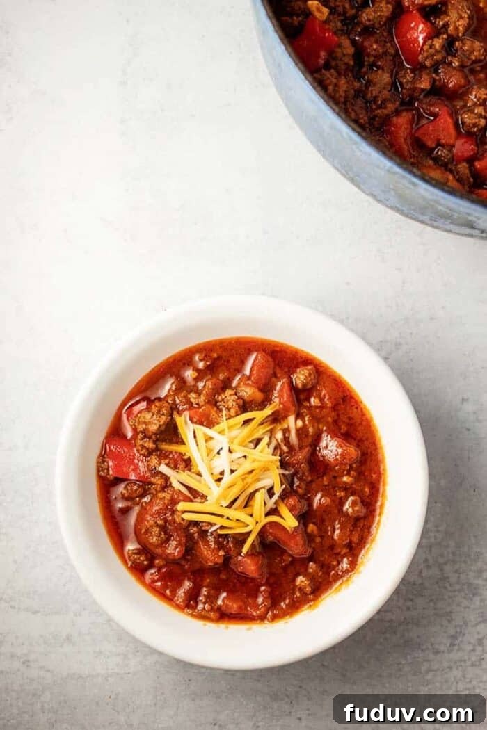 overhead view of bowl of keto chili next to pot of chili