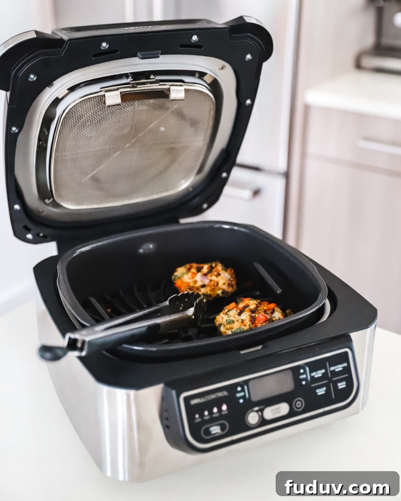 Ninja Foodi Pro Grill with turkey burgers and potatoes