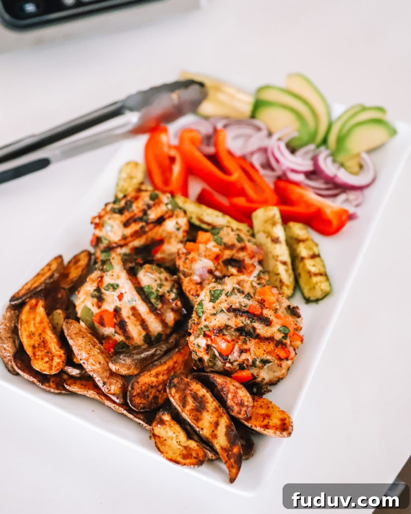 Plated grilled turkey burger with potatoes and zucchini