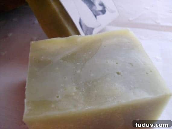 Top Essential Oil Blend Recipes for Soap Making 7 Image shows a large block of orange mint soap sitting on a tile counter