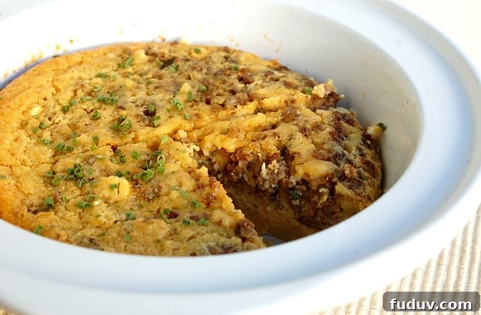 Crock Pot Egg and Sausage Breakfast Casserole in white crock pot.