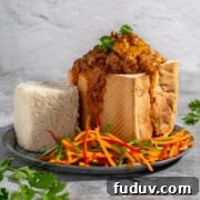 A quarter bunny chow on a plate with a carrot sambal on the side.