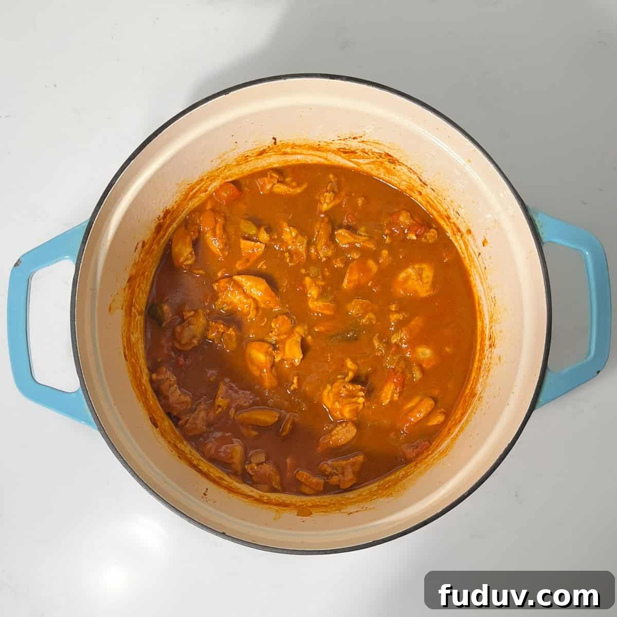 Cooked bunny chow in a large saucepan.