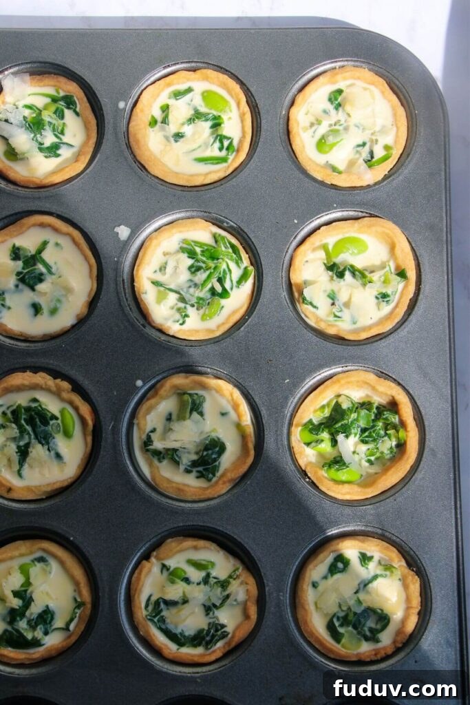 Mini coronation quiches in mini muffin tin, ready to bake.