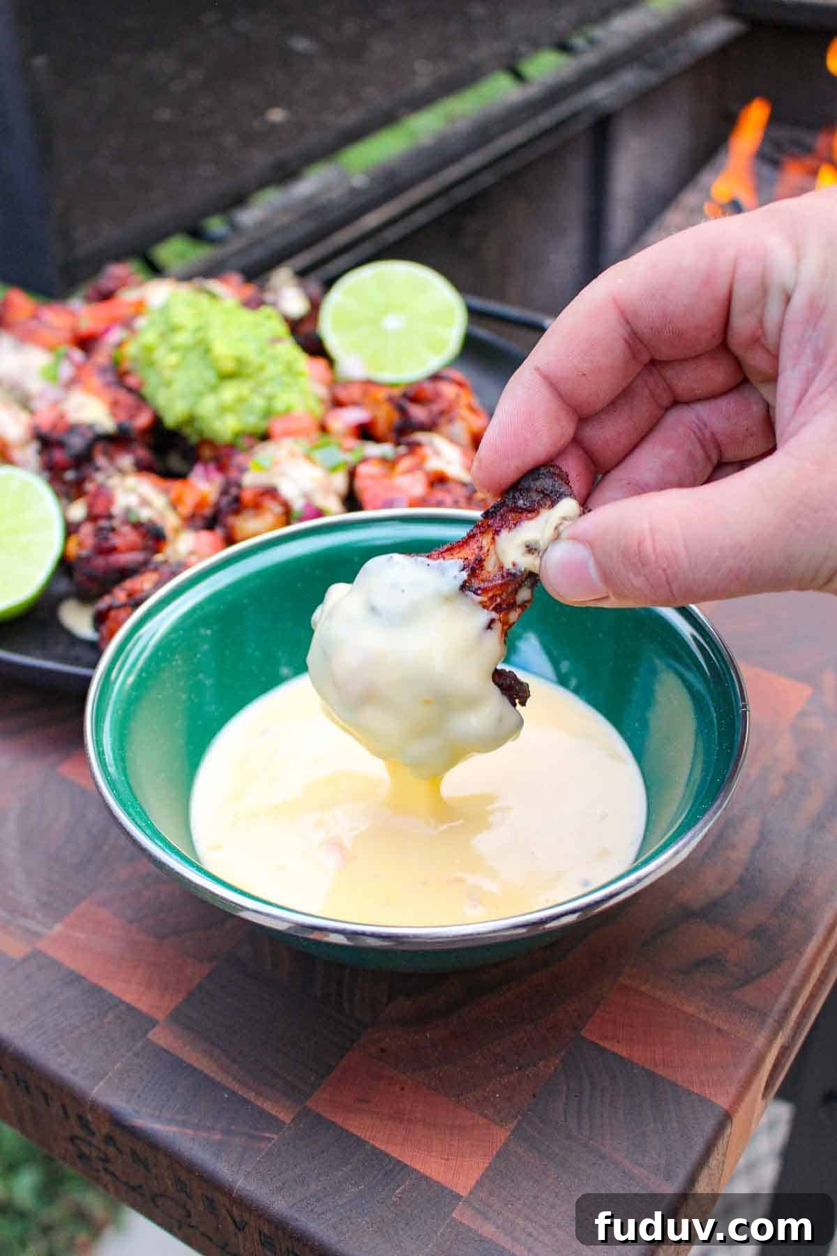 A chicken wing dipped in the nacho cheese sauce.