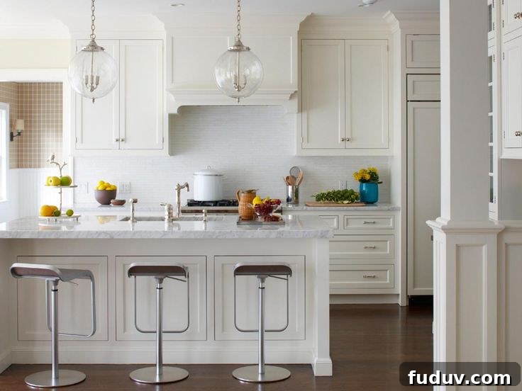 25+ Stunning All-White Kitchen Designs for Timeless Style 15 Tranquil White Kitchen With Polish Nickel Bar Stools | 25+ Dreamy White Kitchens