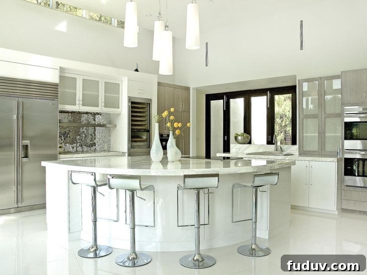 25+ Stunning All-White Kitchen Designs for Timeless Style 20 Contemporary White Kitchen with Eat-In Island | 25+ Dreamy White Kitchens