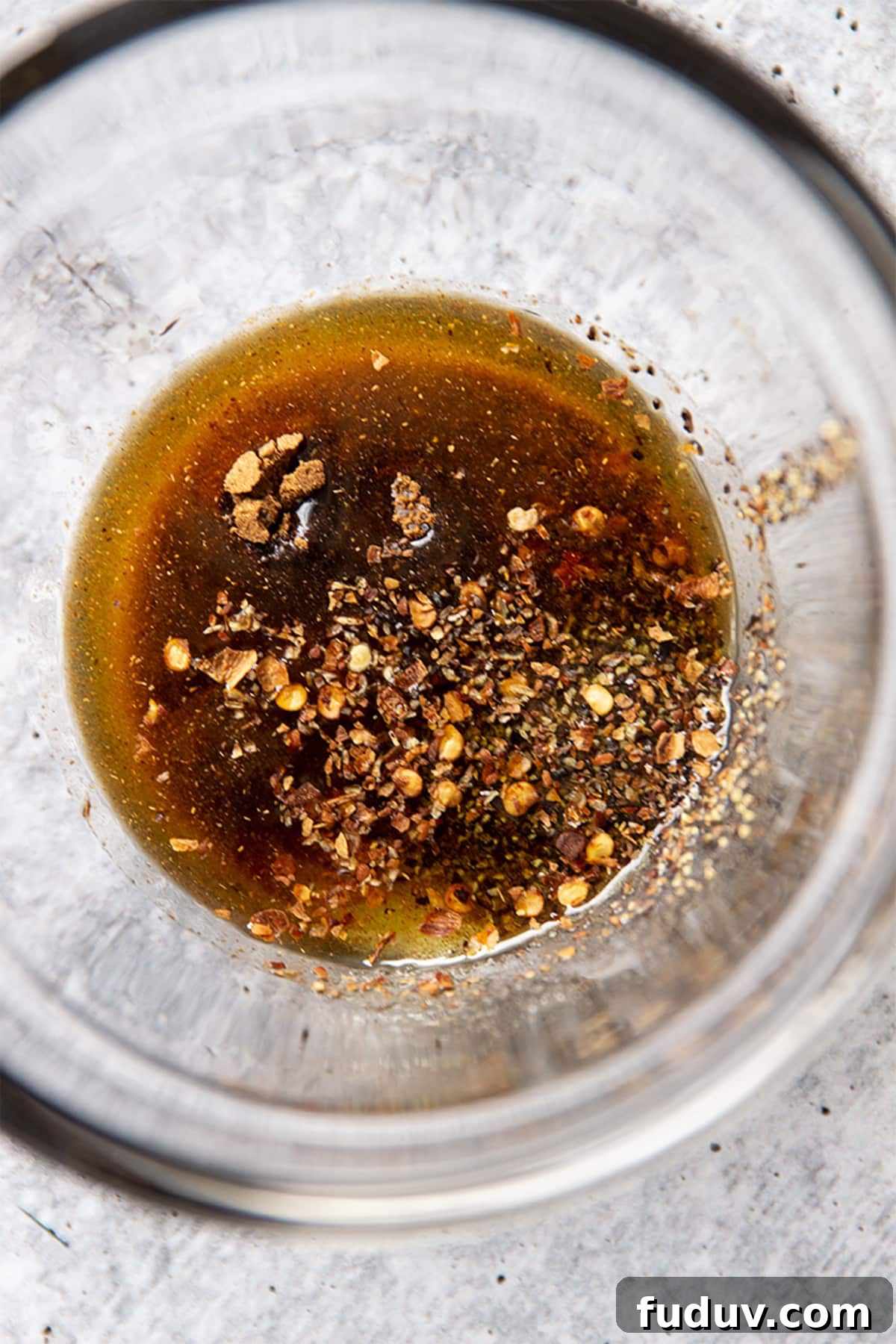 Chinese marinade sauce in glass dish on counter.