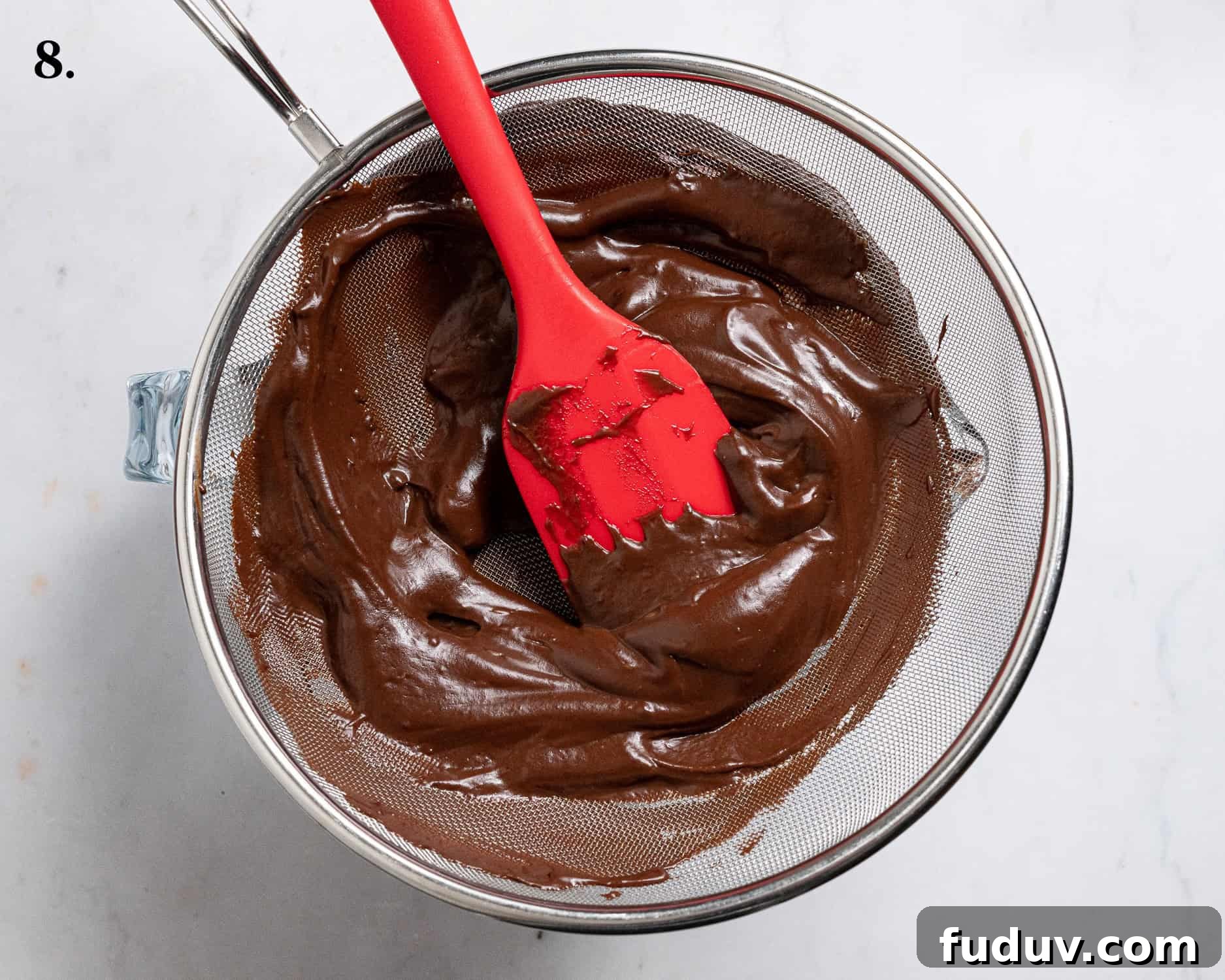 Step 8, scraping the chocolate pudding through a sieve.