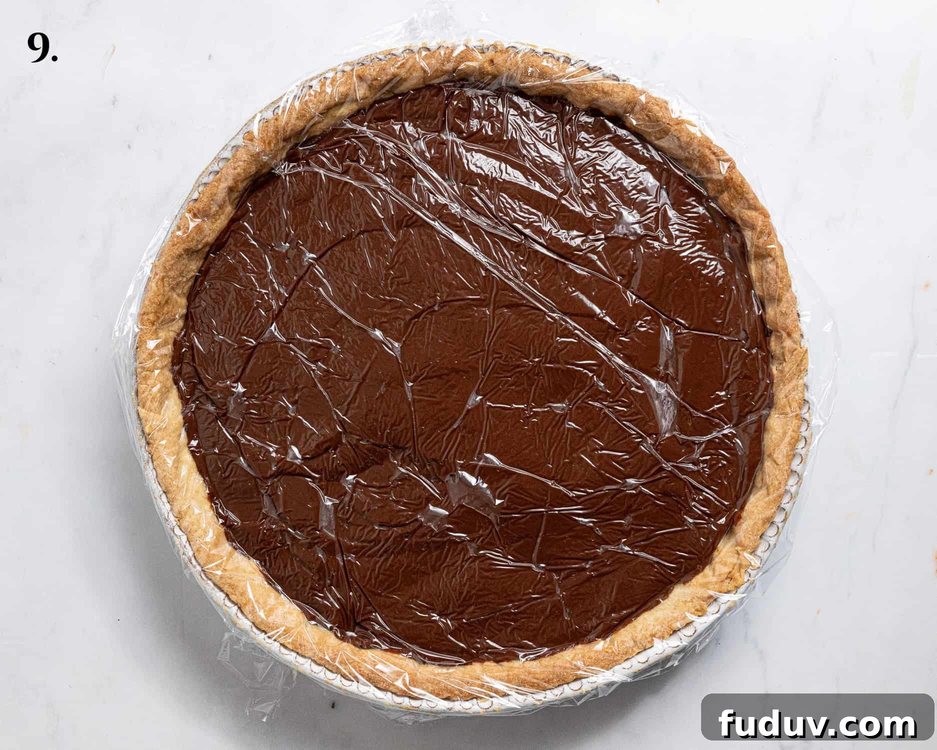 Step 9, the chocolate pudding in the pastry case covered with clingfilm.