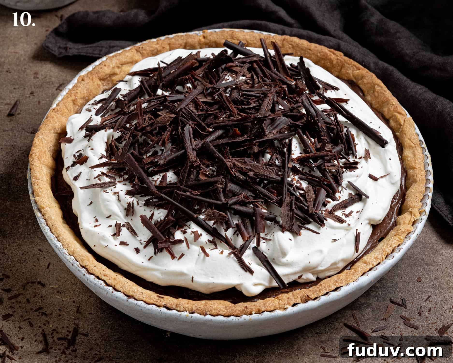 Step 10, the assembled pie with whipped cream and chocolate shavings on top.