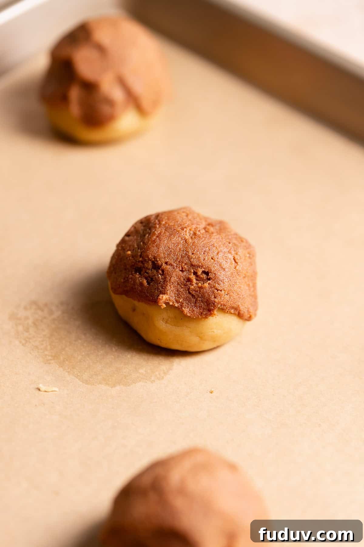A cookie dough ball with cinnamon sugar filling on top.