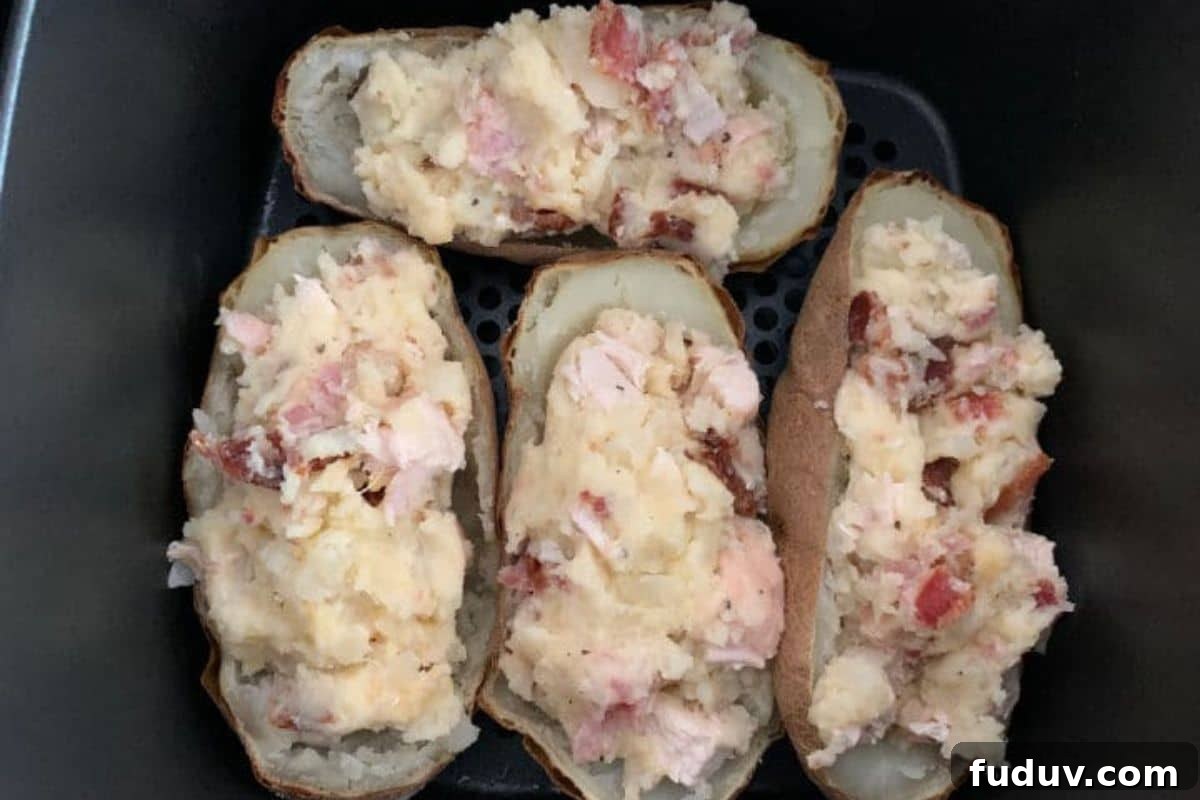 Air Fryer Twice-Baked Potatoes with Chicken and Crispy Bacon 6 The stuffed potatoes ready to cook in the air fryer again.