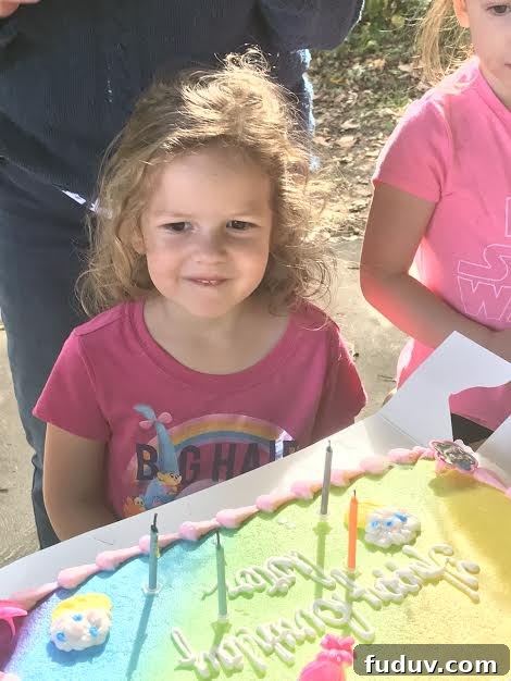 Aster beaming over her cake