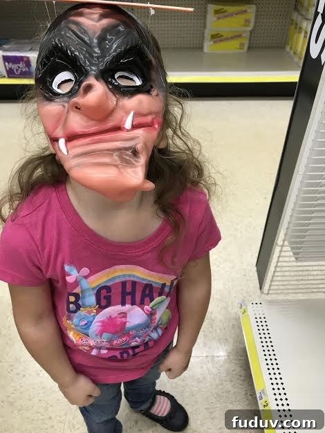 Aster trying on a Halloween mask