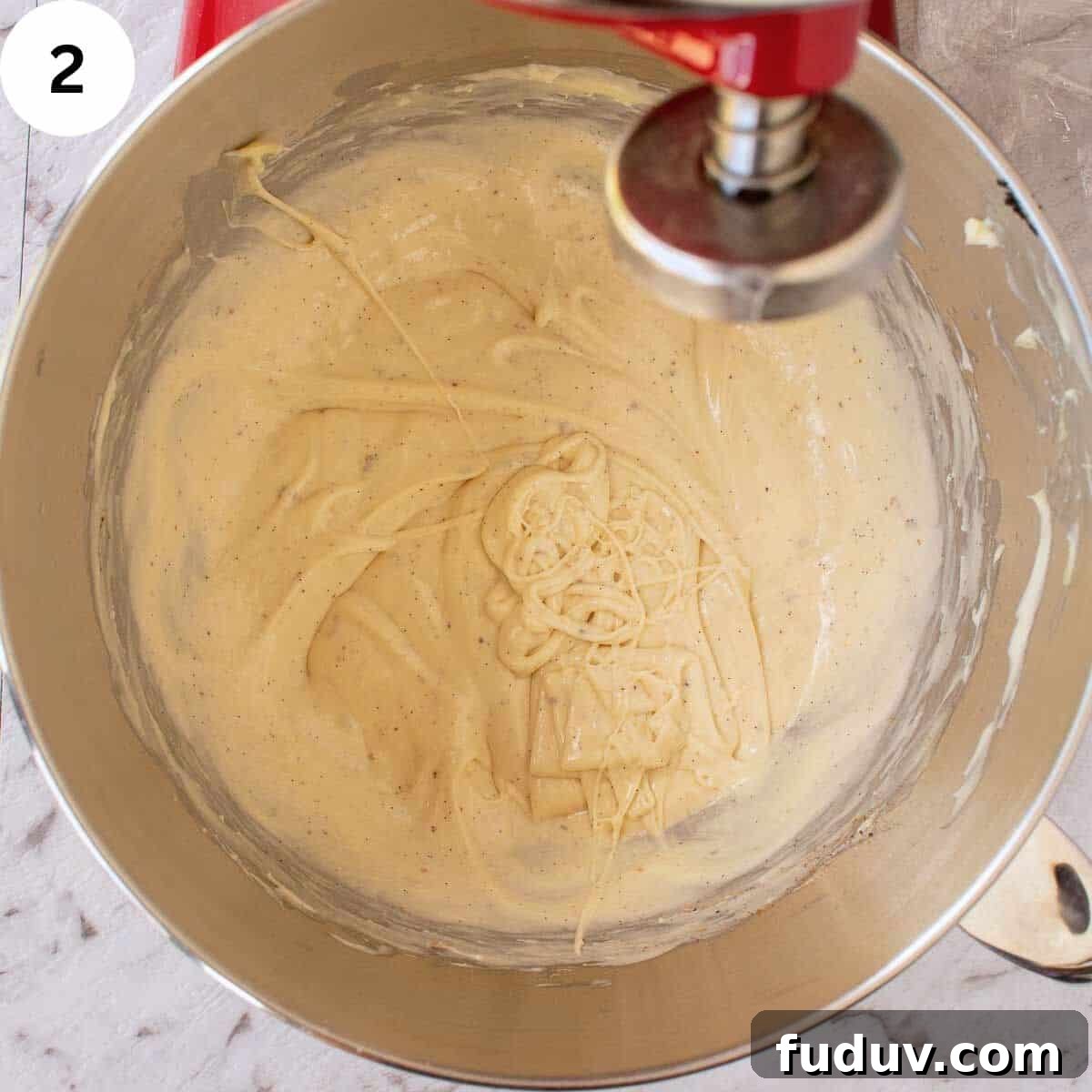 Traditional German Stollen Recipe: Classic Holiday Fruit Bread 5 Thick batter with flecks of vanilla through it in a stainless steel bowl.