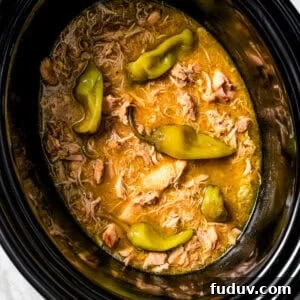 Mississippi-Style Slow Cooker Chicken with Creamy Pepperoncini Sauce 4 Overhead view of Mississippi chicken inside the slow cooker.