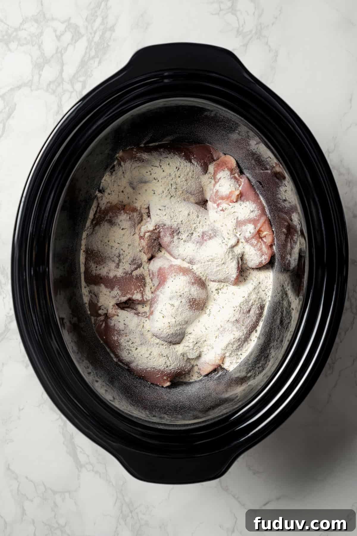 Mississippi chicken is an easy crock pot recipe with juicy chicken shredded in savory pepperoncini ranch sauce. Make it with 5 ingredients! Chicken thighs topped with ranch mix and onion soup mix inside the slow cooker.