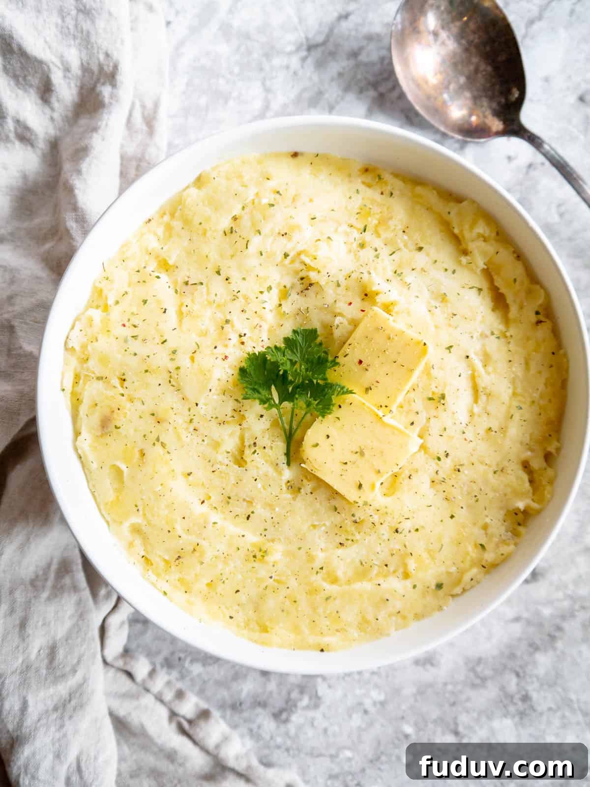 Smooth mashed potatoes with cottage cheese in a bowl.
