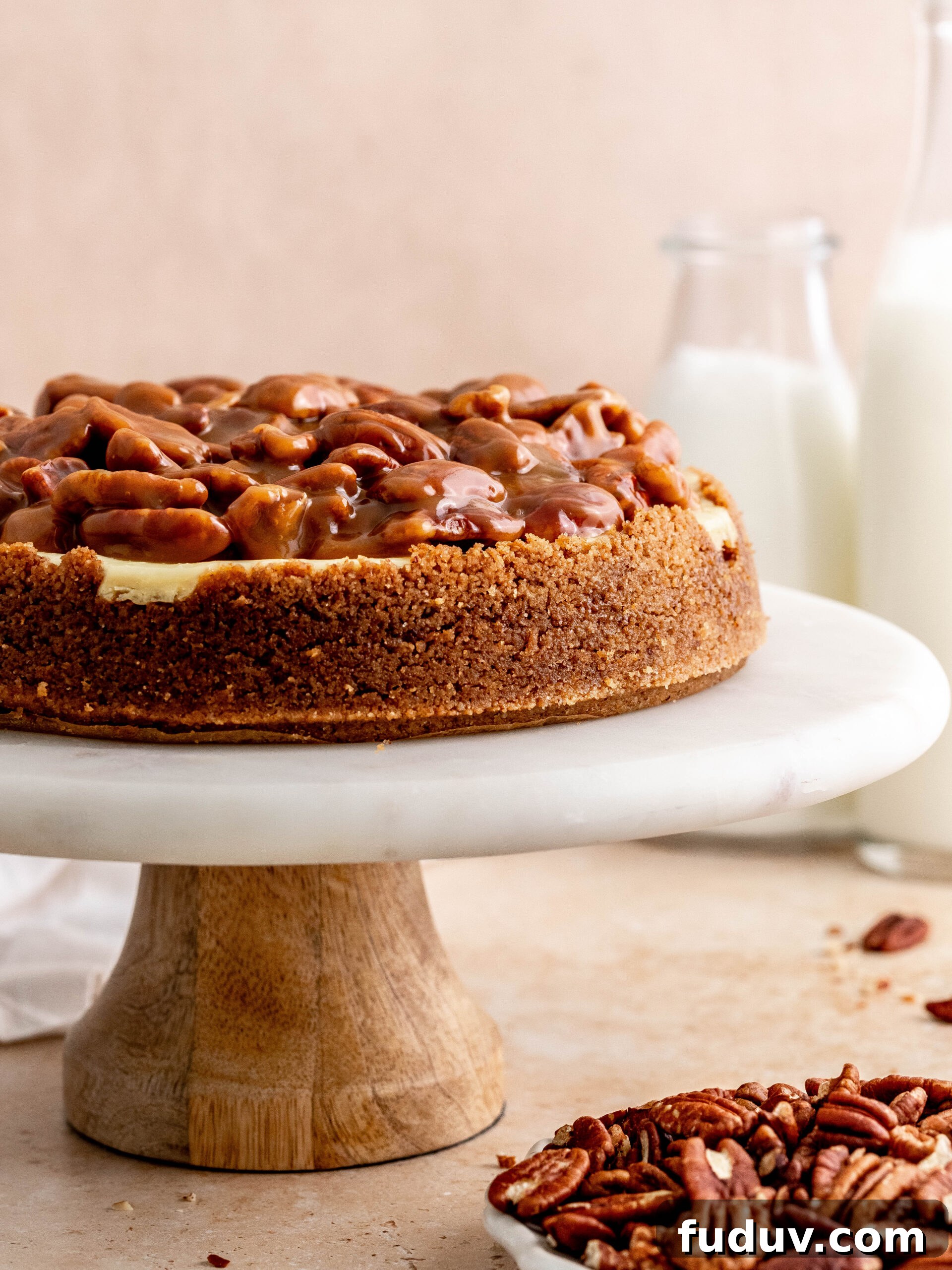 Caramel pecan cheesecake on a cake stand