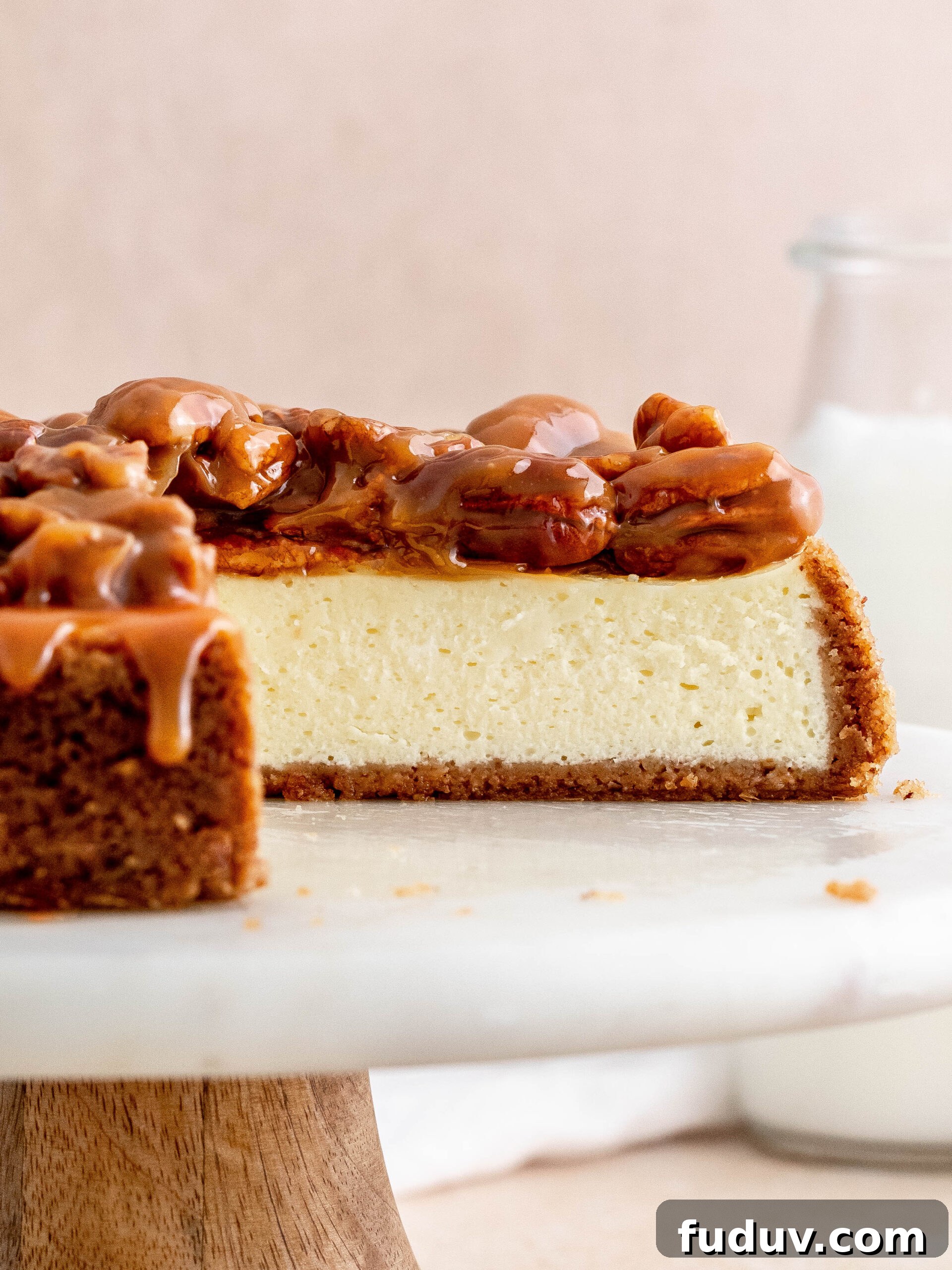 Caramel pecan cheesecake on a cake stand