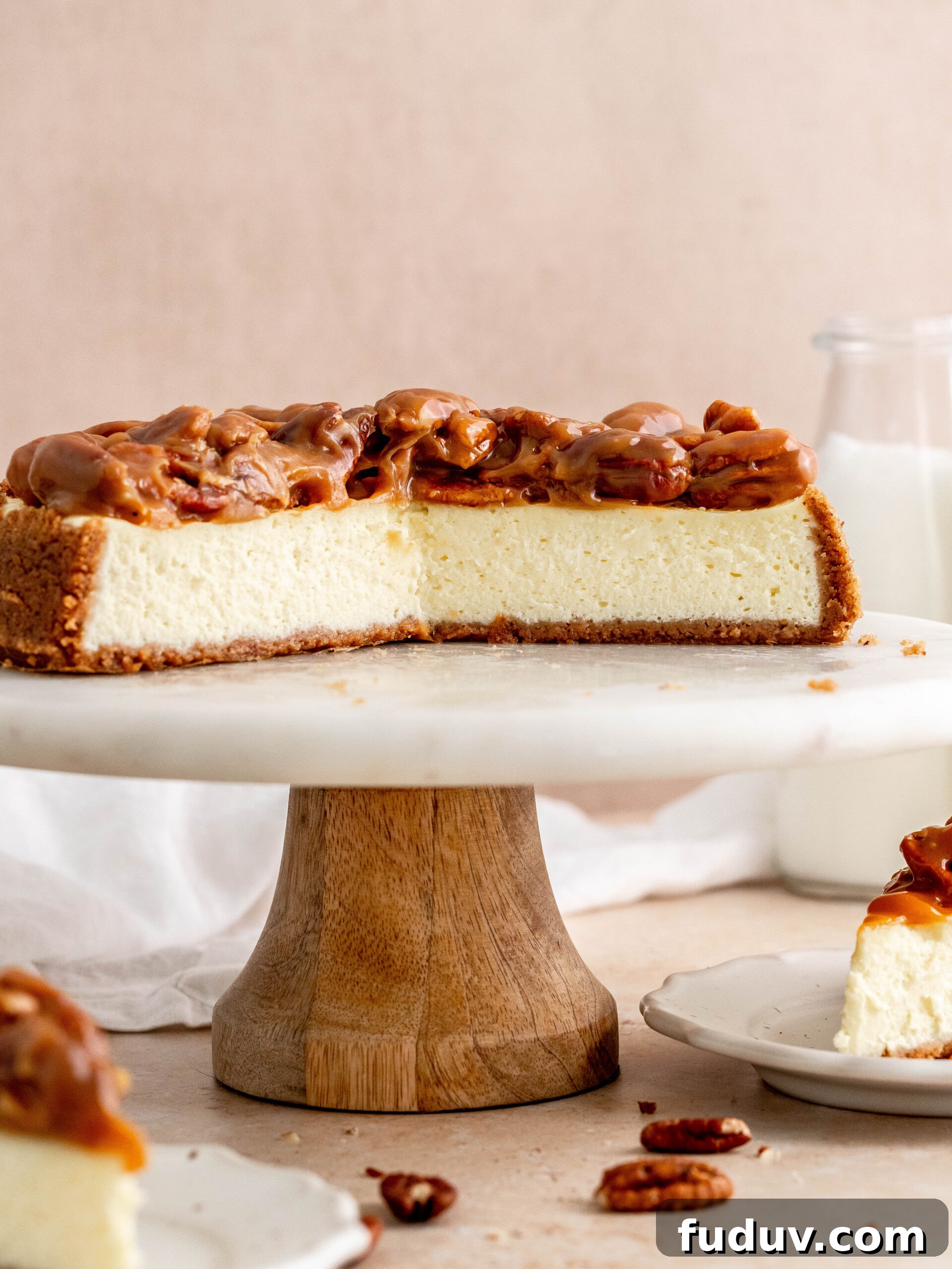 Caramel pecan cheesecake on a cake stand