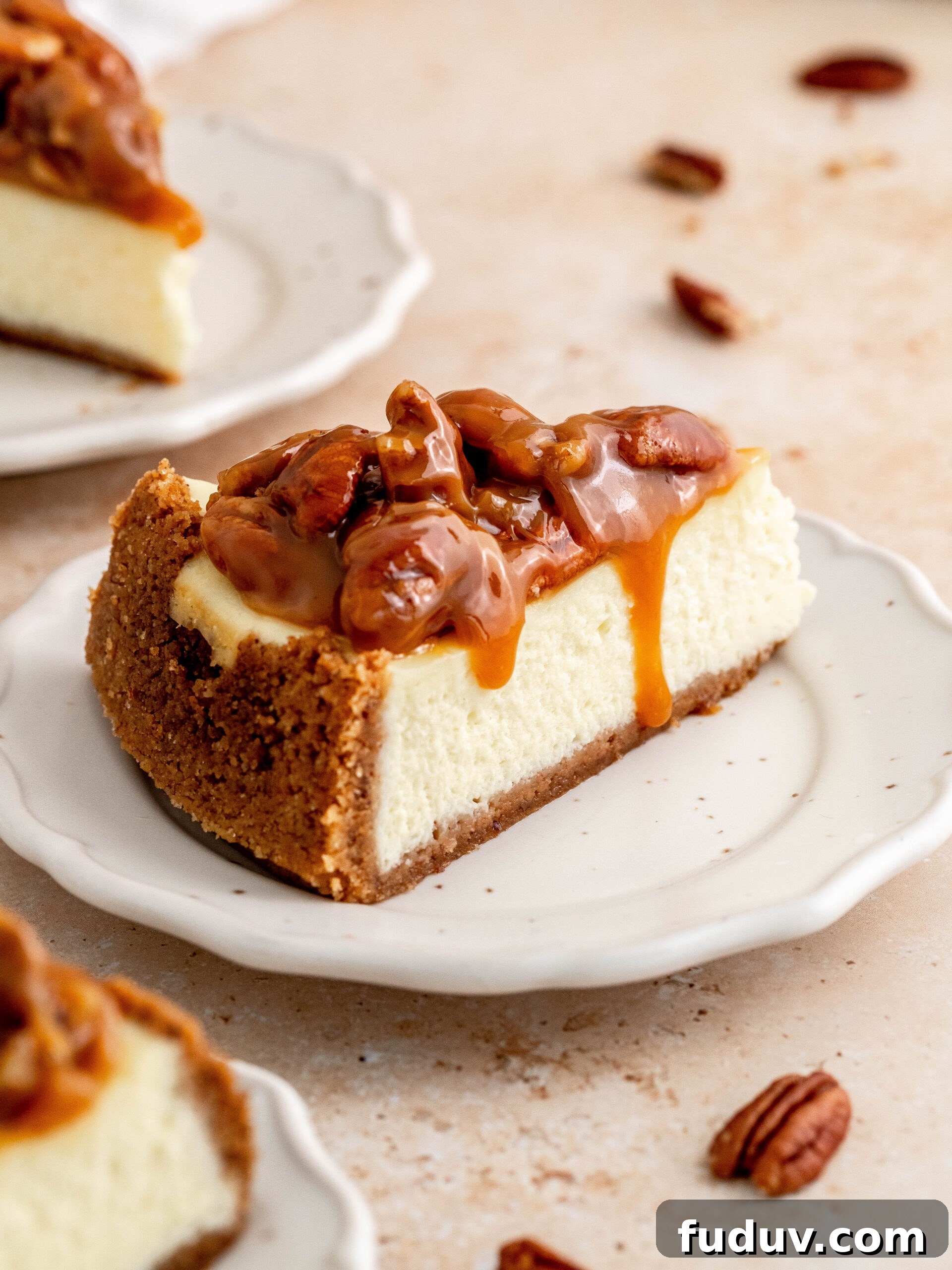 A slice of caramel pecan cheesecake on a plate.