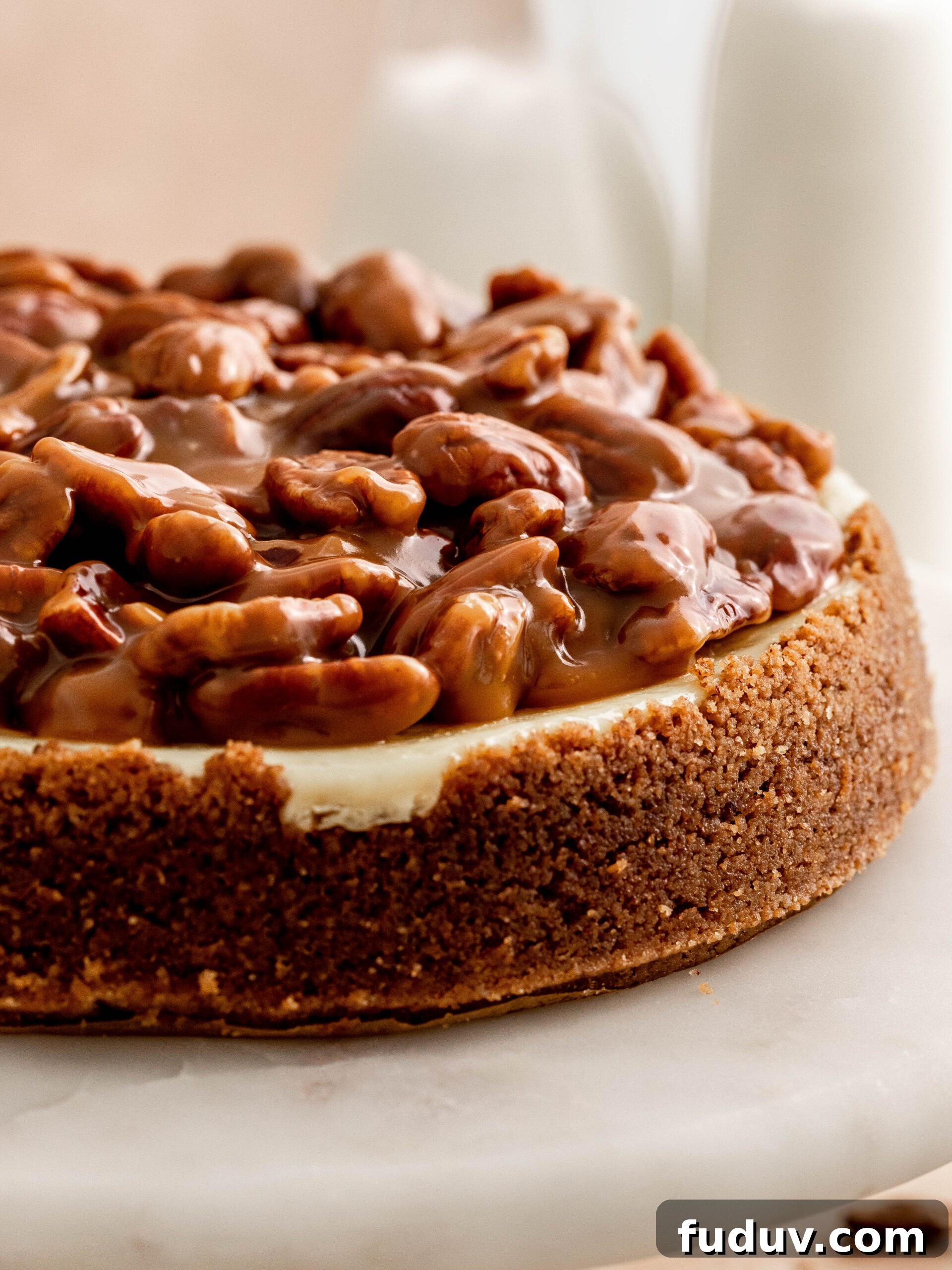 Caramel pecan cheesecake on a cake stand