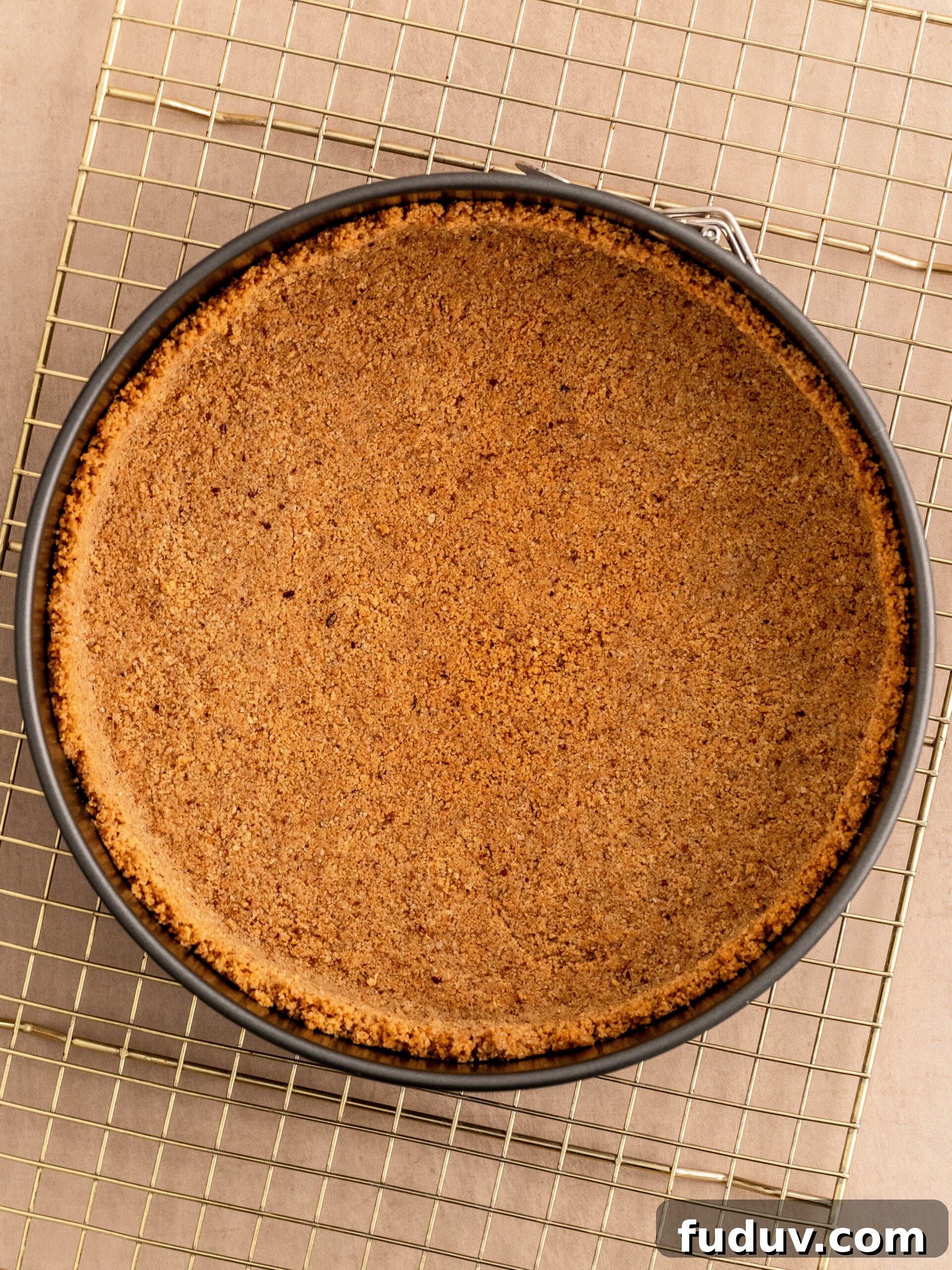 Step 4. Add the cookie crumble to the spring-form and press it down. 