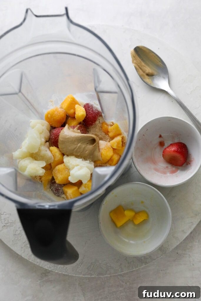 frozen mango, cauliflower, and strawberries in blender with cashew butter 