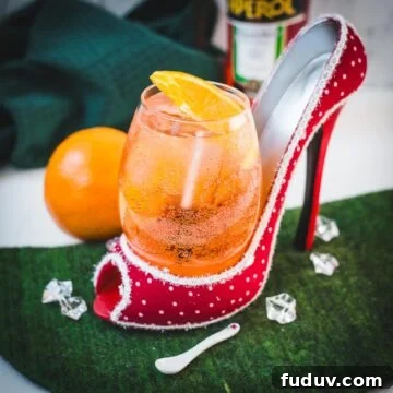 Aperol Spritz Made with Wine: How to Swap Prosecco for Table Wine 5 Aperol spritz with white wine instead of prosecco playfully served in a red and white polka dot high heel. Garnished with n orange slice.
